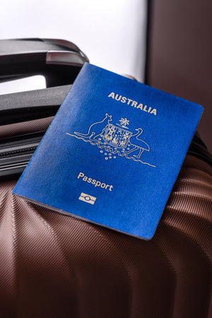 International passport of a citizen of Australia on a suitcase, departure from the airport, international travelの写真素材