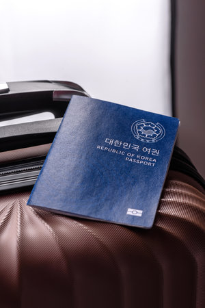 International passport of a citizen of South Korea on a suitcase, departure from the airport, international travelの写真素材