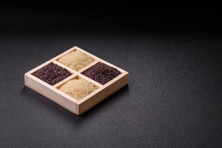 White and red raw rice grains in a wooden box. Rice as an ingredient in Asian organic food