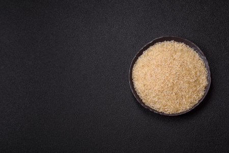 White raw rice in a ceramic bowl. Rice as an ingredient in Asian foodの写真素材