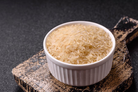 White raw rice in a ceramic bowl. Rice as an ingredient in Asian foodの写真素材