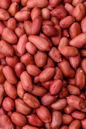 Peanuts or peeled graundnut in a bowl on a dark concrete background. Nut as a source of proteinの写真素材