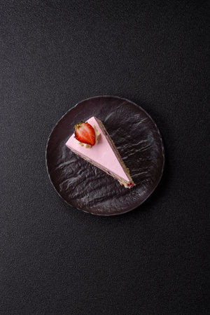 A slice of pink colored puff cake for a birthday celebration. Sweets to celebrate a wedding or valentine's dayの写真素材