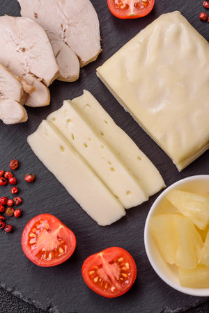Dairy white mozzarella cheese sliced as an ingredient for caprese salad with tomatoesの写真素材