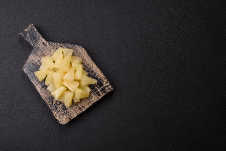 Tropical sweet pineapple fruit sliced into slices. Pineapple as an ingredient for pizza or salad