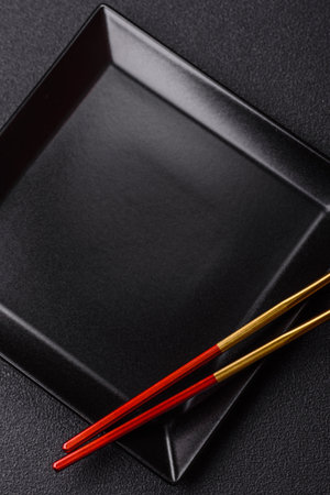 An empty plate with chopsticks for Japanese or Chinese food. Kitchen empty plate for Asian food