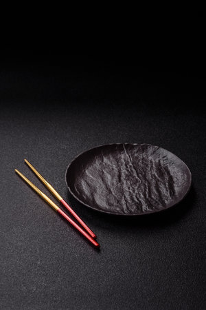 An empty plate with chopsticks for Japanese or Chinese food. Kitchen empty plate for Asian foodの写真素材