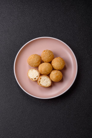 Cheese fried balls or croquettes with potatoes or rice. Snacks, fast foodの写真素材