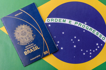 Brazilian passport against the background of the national flag of Brazil. Document for travel and businessの写真素材