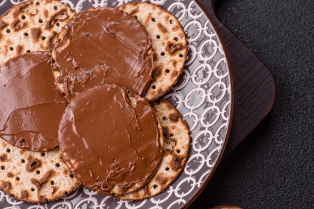 Matzah with chocolate paste for the Jewish holiday of passover for the festive tableの写真素材
