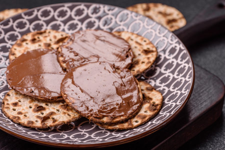 Matzah with chocolate paste for the Jewish holiday of passover for the festive tableの写真素材