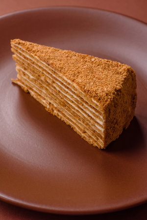 A slice of honey puff cake or pumpkin, carrot and cream pie, vegan sweets for the dinner table