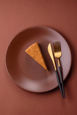 A slice of honey puff cake or pumpkin, carrot and cream pie, vegan sweets for the dinner tableの写真素材