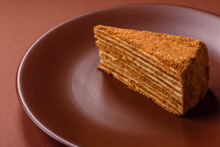 A slice of honey puff cake or pumpkin, carrot and cream pie, vegan sweets for the dinner tableの写真素材