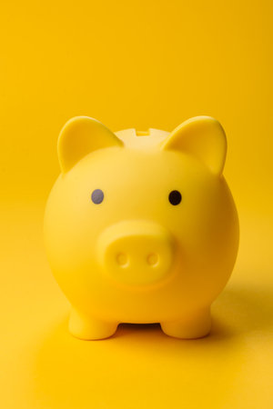 Piggy bank as a financial conceptual background with coins, doing business, saving money, paying taxes and paying off loansの写真素材