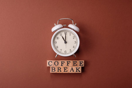 Alarm clock and coffee break lettering as a conceptual backdrop for a work break or meeting. Wallpaper for your designの写真素材