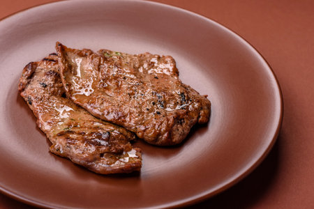 Steak, grilled beef, sirloin cooked on the barbecue with salt, spices and herbsの写真素材