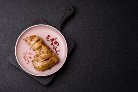 Grilled chicken leg or quarter. Barbecueed meat with salt and spices on a ceramic plateの写真素材