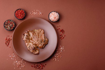 Steak, grilled beef, sirloin cooked on the barbecue with salt, spices and herbsの写真素材