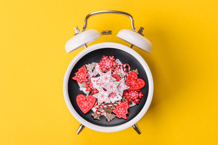 Christmas, gingerbread or biscuits on a plate on a vintage clock. Festive sweets and pastries