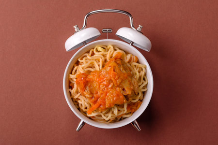 Italian pasta with meat, sauce and vegetables on a vintage background. Conceptual background time to eat pastaの写真素材