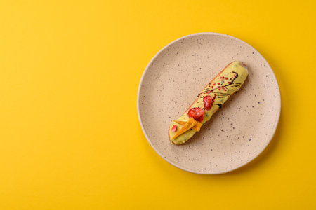 French food, dessert eclair with chocolate filling and covered with colored icing. Sweet eclair as a background for your designの写真素材