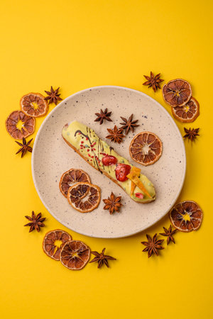 French food, dessert eclair with chocolate filling and covered with colored icing. Sweet eclair as a background for your designの写真素材