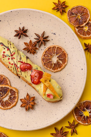 French food, dessert eclair with chocolate filling and covered with colored icing. Sweet eclair as a...