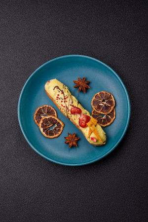 French food, dessert eclair with chocolate filling and covered with colored icing. Sweet eclair as a...