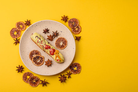 French food, dessert eclair with chocolate filling and covered with colored icing. Sweet eclair as a...