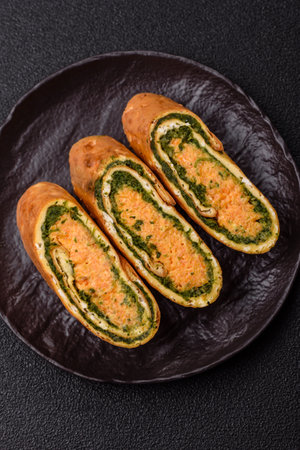 Roll of omelette, spinach, cheese and minced meat.