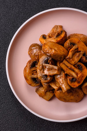 Food, baked mushrooms champignon slices with sauce and spices. Background of grilled mushroomsの写真素材