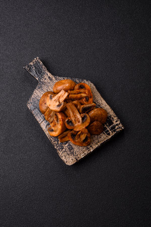 Food, baked mushrooms champignon with sauce and spices. Background of grilled mushroomsの写真素材