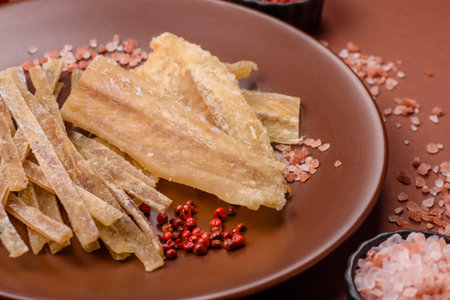 Dried salted fish, snacks or jerky, slices of fish fillets.