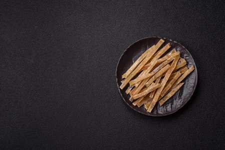 Food, snacks or jerky made from dried dehydrated salted fish with spices.の写真素材