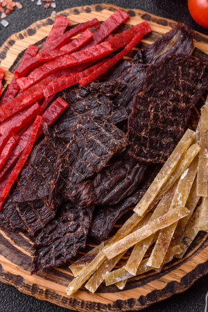 A set of jerky or snacks of beef, chicken and fish with salt and spices.の写真素材