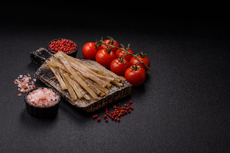 Food, snacks or jerky made from dried dehydrated salted fish with spices. Snacks fish dry sticks