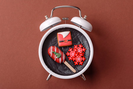 Christmas, eclair on a plate on a vintage clock. Christmas time conceptual background, festive...