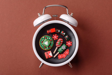 Christmas, eclair on a plate on a vintage clock. Christmas time conceptual background, festive sweets and pastriesの写真素材
