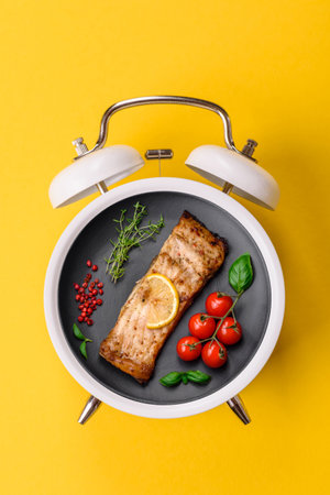 Red salmon fish grilled with pepper and spices. Concept time to eat fish, grilled salmon on a plateの写真素材