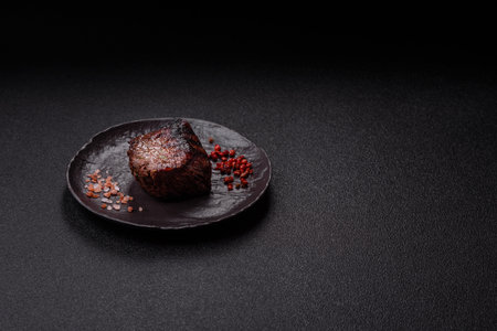 Grilled beef steak meat with salt and pepper. Beef steak grilled on a barbecue as a background for your designの写真素材