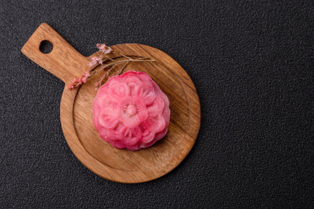 Chinese mooncake is an Asian sweet dessert with a coating of rice dough and fruit filling. Asian mooncake as a background for your designの写真素材