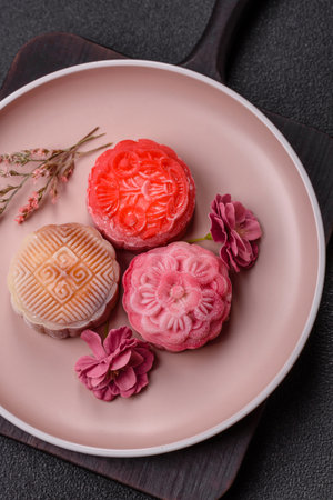 Chinese mooncake is an Asian sweet dessert with a coating of rice dough and fruit filling. Asian mooncake as a background for your designの写真素材
