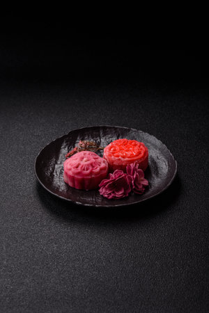 Chinese mooncake is an Asian sweet dessert with a coating of rice dough and fruit filling. Asian...