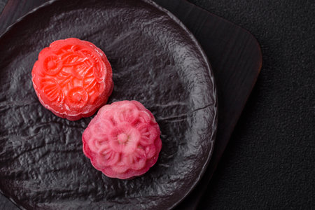 Chinese mooncake is an Asian sweet dessert with a coating of rice dough and fruit filling. Asian mooncake as a background for your designの写真素材