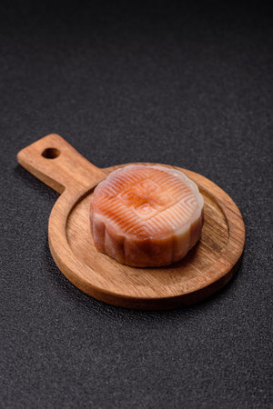 Chinese mooncake is an Asian sweet dessert with a coating of rice dough and fruit filling. Asian...