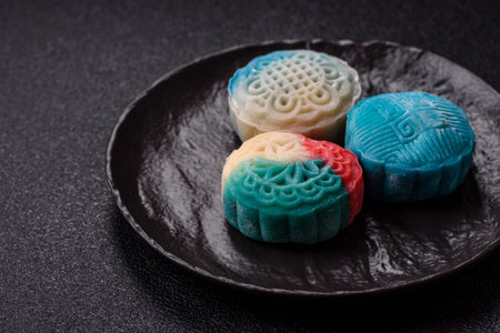Chinese mooncake is an Asian sweet dessert with a coating of rice dough and fruit filling. Asian...