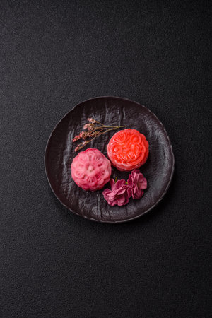Chinese mooncake is an Asian sweet dessert with a coating of rice dough and fruit filling. Asian...