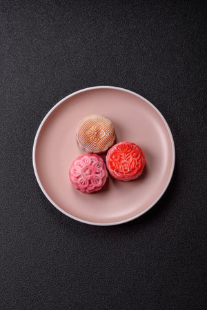 Chinese mooncake is an Asian sweet dessert with a coating of rice dough and fruit filling. Asian mooncake as a background for your designの写真素材