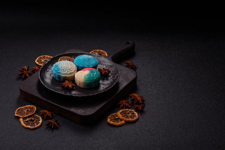 Chinese mooncake is an Asian sweet dessert with a coating of rice dough and fruit filling. Asian mooncake as a background for your designの写真素材